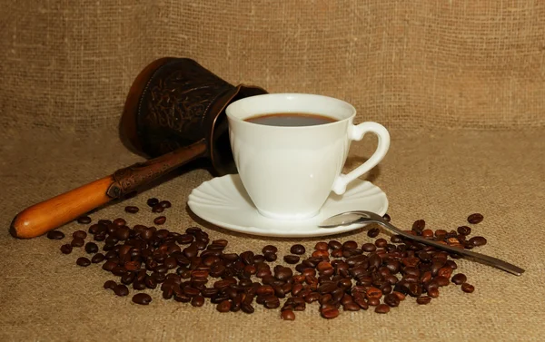 A cup of coffee, coffee beans and a Turk — Stock Photo, Image