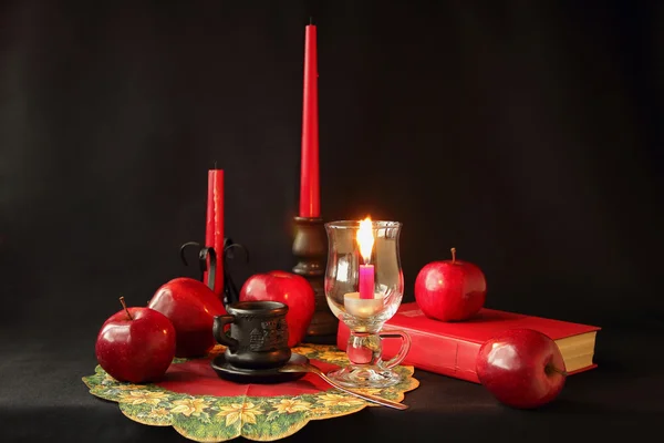 Candles, a book, a cup of coffee and apples — Stock Photo, Image
