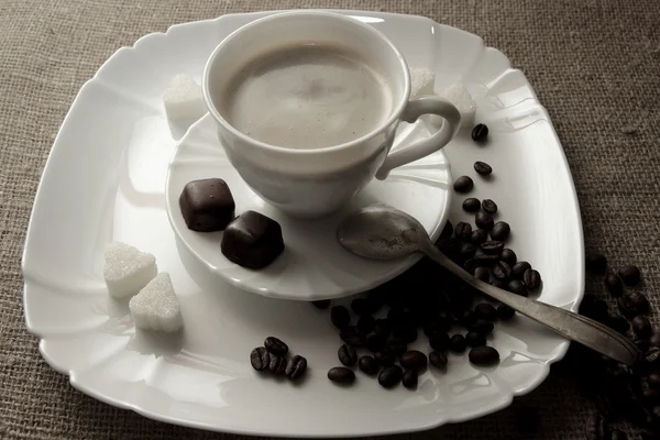Cup of coffee with cream and truffle — Stock Photo, Image