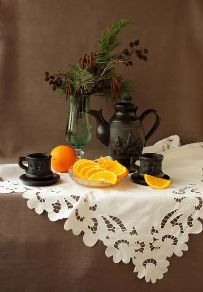 Coffee service, oranges and candy on a white napkin — Stock Photo, Image