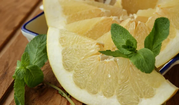 Slice of Pomelo and sprig of mint — Stock Photo, Image