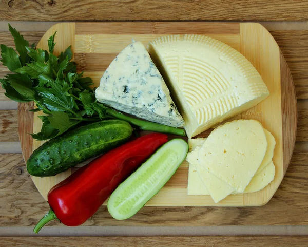 Cheese, homemade cheese and vegetables, top view — Stock Photo, Image