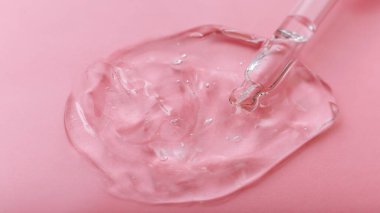 Pembe arka planda pipette şeffaf jel hyaluron serumu. Cilt sağlığı için kozmetik ürünlerin su dokusu jeli yüzeyi. Kimyasal jel örneği. Uzun web pankartı