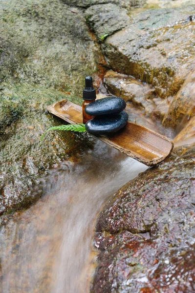 Essence oil and zen stone in spa concept — Stock Photo, Image