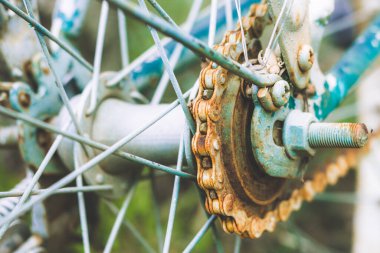 Close up of old rusty chain from the bicycle on background nature ,Bicycle's detail view of wheel with old chain, sprocket,dirty chain (Vintage tone) 