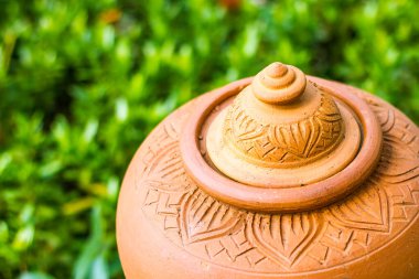 Closed up of orange baked clay pot,Clay pots for cooking outside a restaurant on background nature