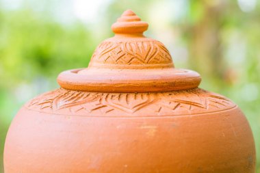 Closed up of orange baked clay pot,Clay pots for cooking outside a restaurant on background nature