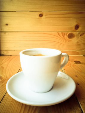 Eski bir tezgahın üzerinde bir fincan kahve.