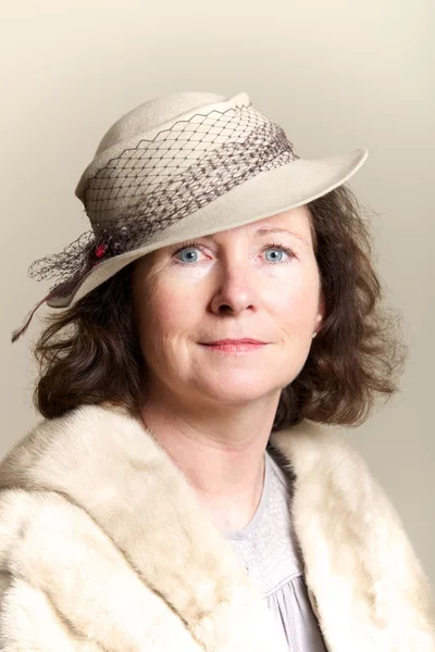 Brunette smiling in beige hat and fur — Stock Photo, Image