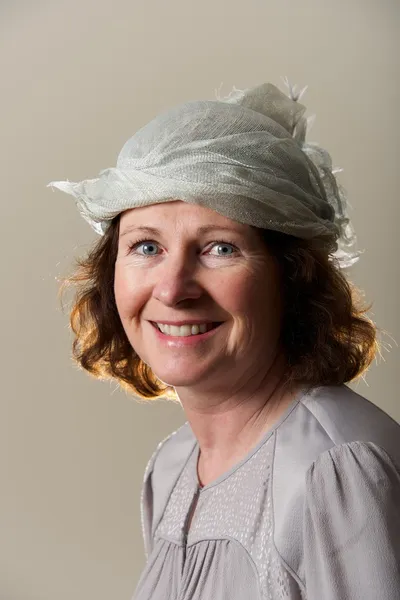 Brunette smiling in silver hat and blouse — Stock Photo, Image