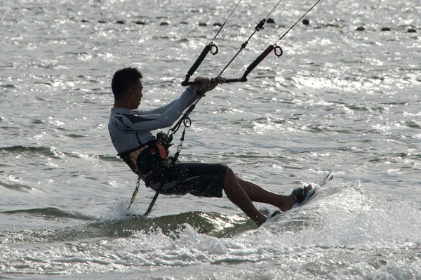 Close-up of male kite surfer leaning over — Stock Photo, Image