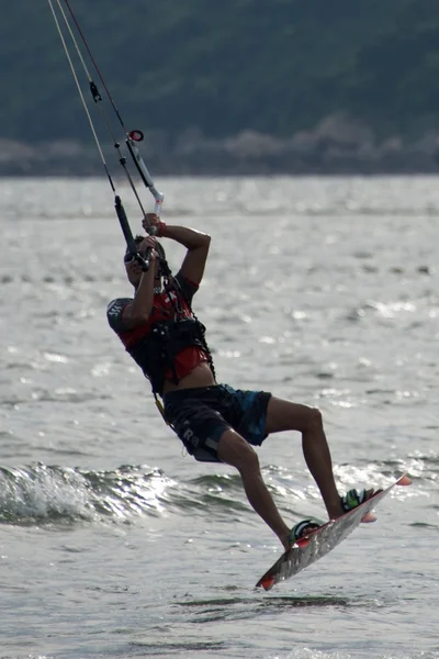Close-up of male kite surfer taking off — Stock Photo, Image