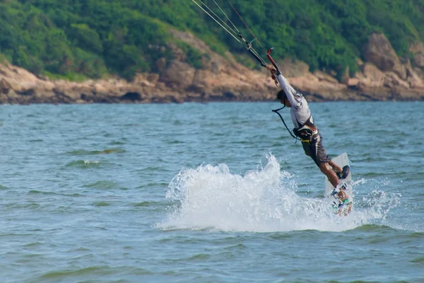 Male kite surfer hanging from his kite — Stock Photo, Image