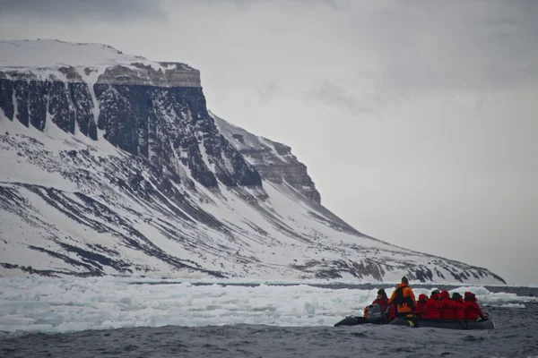 Zodiac crew motor towards headland past ice — Stock Photo, Image