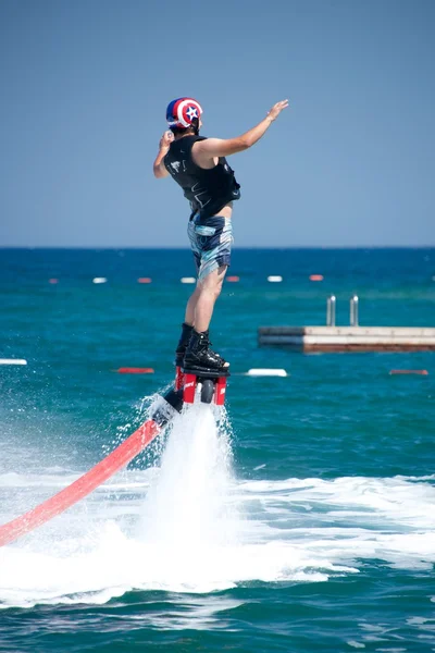 Flyboarder cayendo hacia atrás junto a la plataforma de natación —  Fotos de Stock