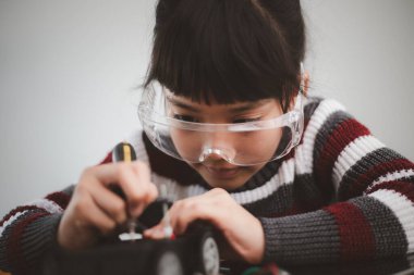 Evde robot araba yapan yaratıcı bir çocuk.