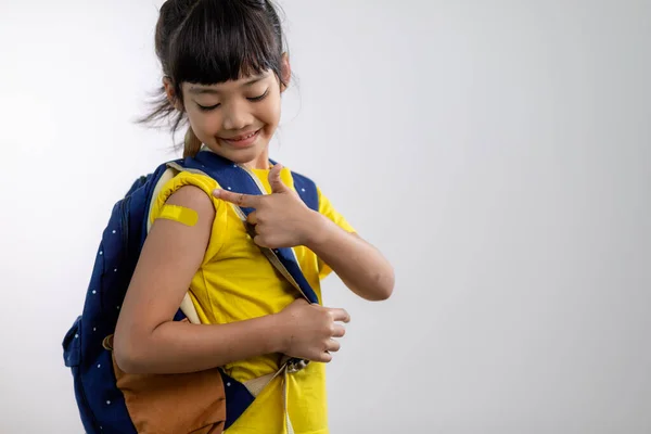 Asian Young Girl Showing Her Arm Yellow Bandage Got Vaccinated — Zdjęcie stockowe
