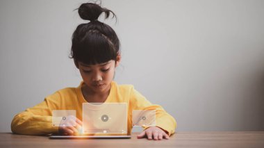 Asyalı kız internet üzerinden yayın yapmak için tablet kullanıyor, internetten video izliyor, canlı eğitim, öğretim, çevrimiçi öğrenim, eğitim, evde eğitim. Covid-19 salgını sırasında....