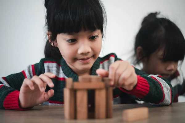 Cheerful Asian Girl Playing Wooden Building Blocks Having Fun Learning — Stockfoto