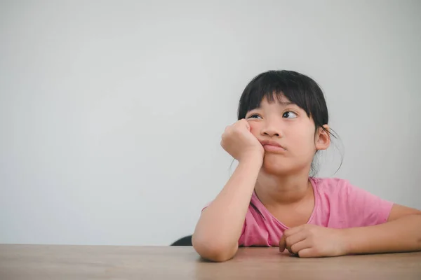 Asian Child Rest Her Cheeks Fists Moody Face — Stock Photo, Image
