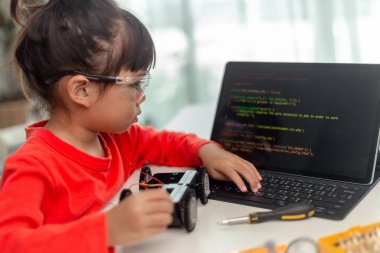 Asyalı öğrenciler evlerinde robot arabaları ve elektronik tahta kablolarını STEM, STEAM, matematik mühendisliği, bilim teknolojisi bilgisayar kodlarını çocuk konsepti için robotikte kodlayarak öğreniyorlar..