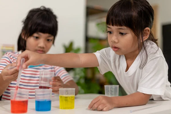 stock image Asian kids do chemical experiments in their home