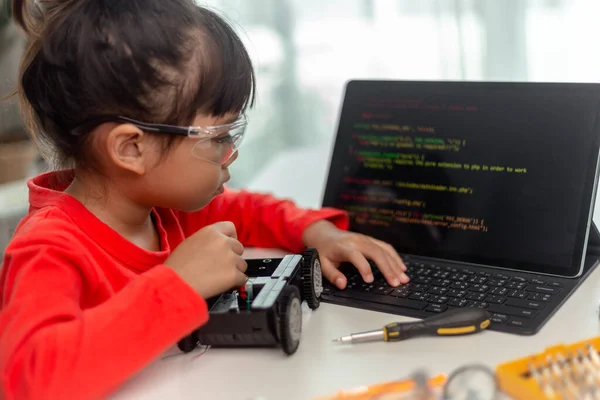 Asia students learn at home in coding robot cars and electronic board cables in STEM, STEAM, mathematics engineering science technology computer code in robotics for kids concept.