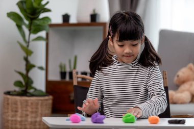 Asyalı çocuklar kil kalıplarıyla oynarlar, oyun oynayarak öğrenirler.