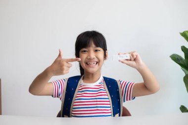 Asyalı kız dersten önce covid-19 testi yaptırıyor..