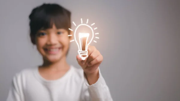 Smart child girl with light bulb idea concept. school concept.