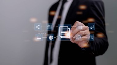 İşadamı yönetim kavramını, çevrimiçi belge veritabanını ve dijital dosya depolama yazılımını, kayıt tutma, veritabanı teknolojisini, dosya erişimini, belge paylaşımını belgelemek için bir bilgisayar kullanıyor.