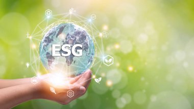 ESG icon concept in the hand for environmental, social, and governance in sustainable and ethical business on the Network connection on a green background.