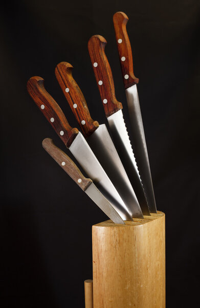 Kitchen knives and their wooden block