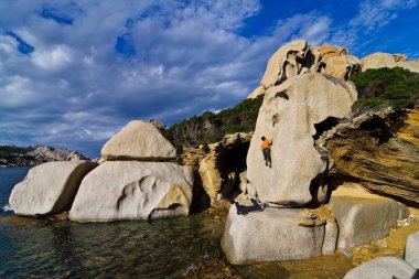 Climber bouldering in Sardinia clipart