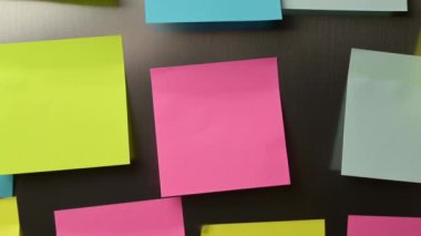 The camera pulls back and shows a large number of stickers on the refrigerator