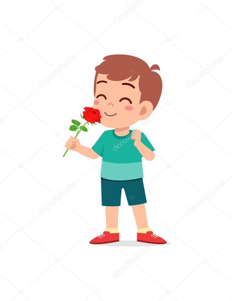 little boy holding flower and sniff the scent