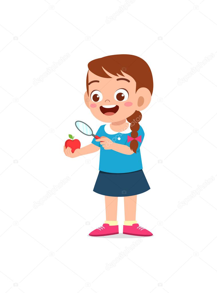 little girl holding apple and magnifying glass