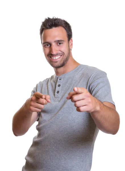 Young man pointing with both hands — Stock Photo, Image