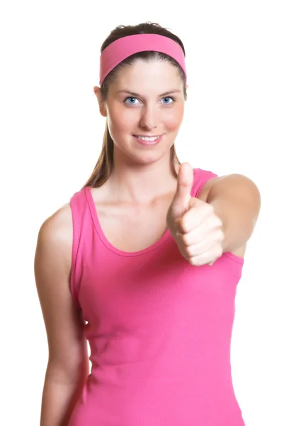 Laughing sporty woman showing thumb — Stock Photo, Image