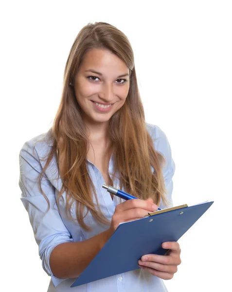 Female secretary writing notes on a clipboard — Stockfoto