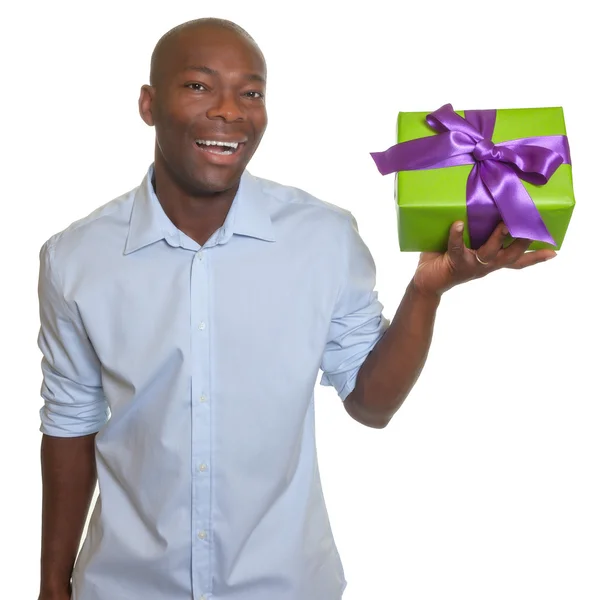 Laughing african man presents a gift — Stock Photo, Image