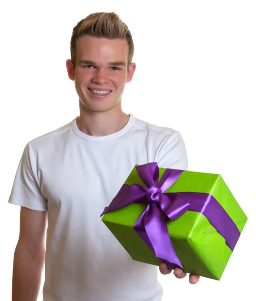 Handsome guy with a christmas gift — Stock Photo, Image