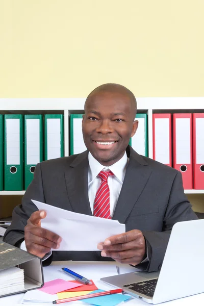 African business man with letter looking at camera — Stock Photo, Image