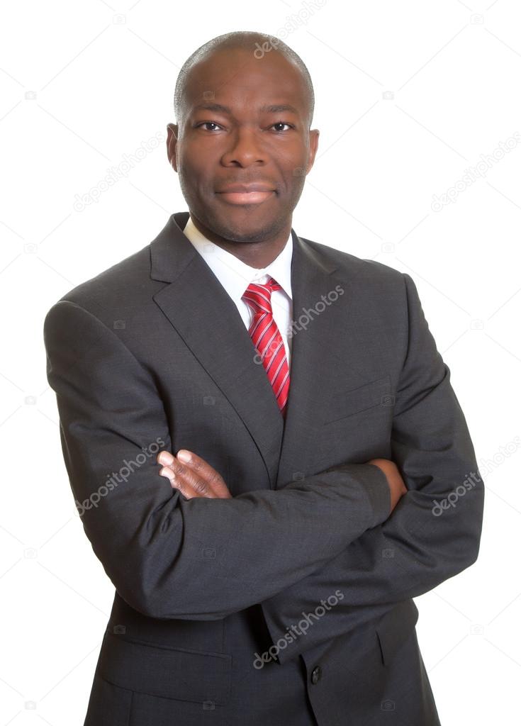 African businessman with crossed arms smiling at camera
