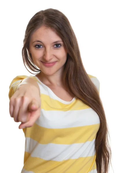 Woman with long brown hair pointing at camera — Stock Photo, Image