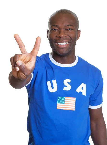 Attractive guy from USA showing victory sign — Stock Photo, Image