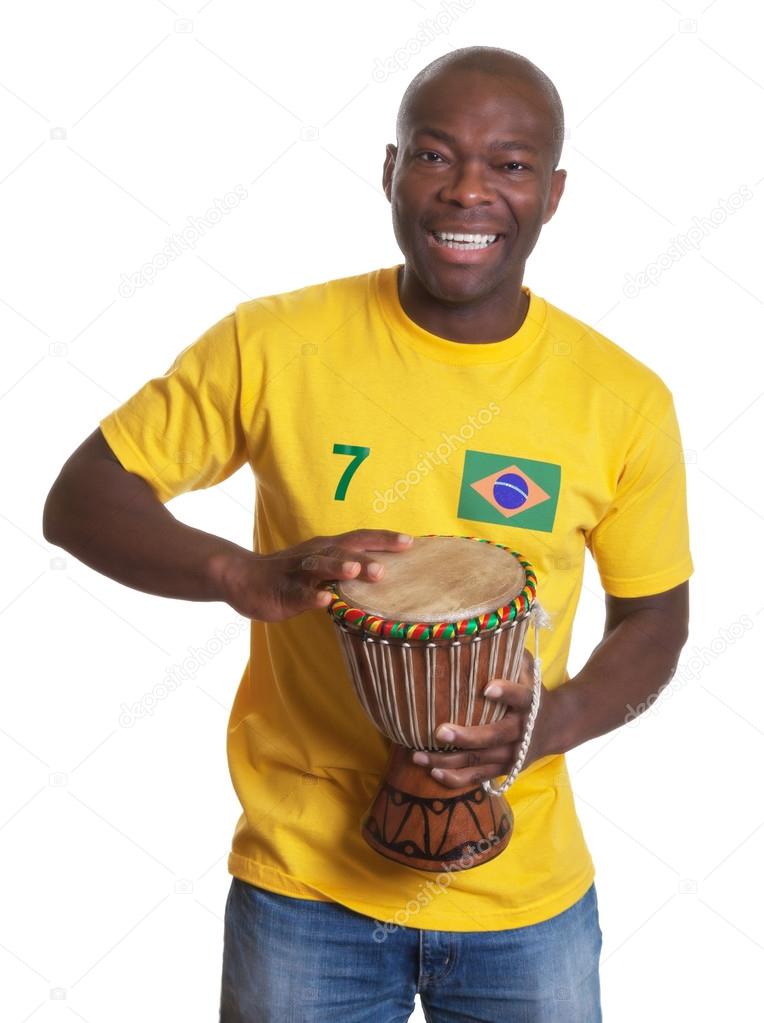 Laughing guy from Brazil with drum supporting his team