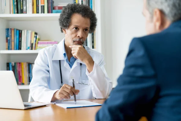 Concerned African American Senior Doctor Listening Patient Office Hospitak — Stock Photo, Image
