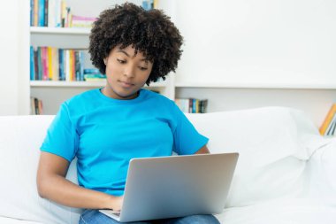 African american female student learning at computer indoors at home