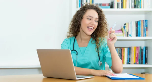 Happy medical student or female nurse at work at hospital with copy space